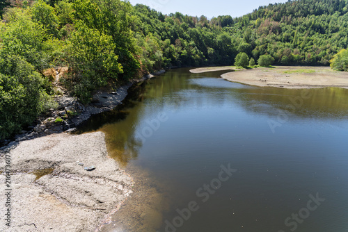 Low water level and exposed shoreline during summer drought in Germany