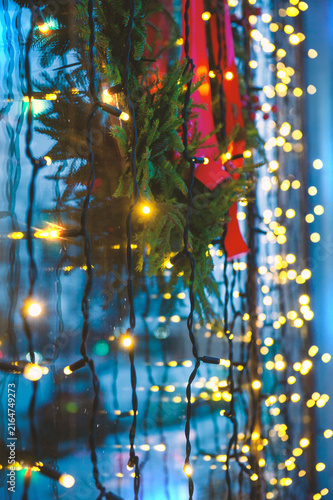 Festive lights glow against glass. Winter decoration adds warmth