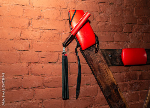 SM cross or Andreaskreuz is used in the BDSM scene on red background