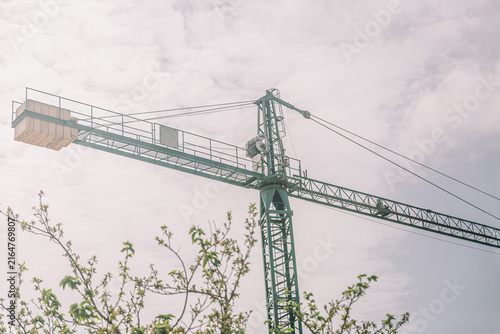 фотографія Tower crane reaching into a cloudy sky