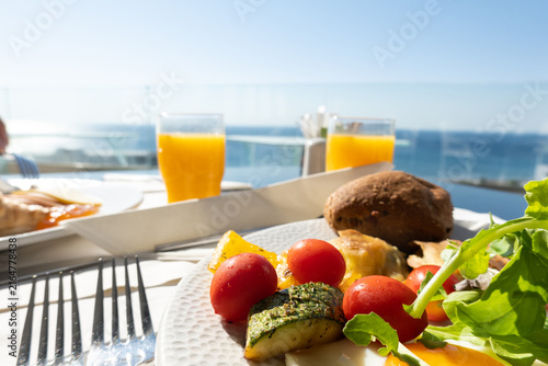 Sea view dining. Healthy hotel breakfast with sea view on a summer holiday. 