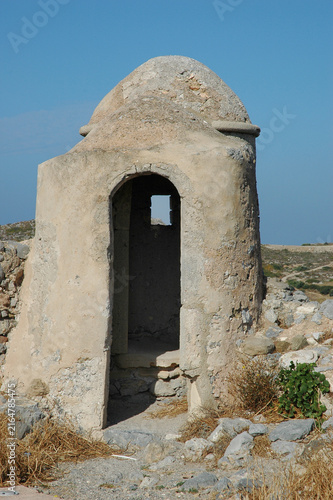 Old stone watchtower on the historical Venetian castle walls of Chora in Kythira Greece under a clear blue sky