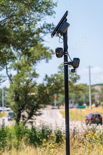 Solar powered automatic license plate reader camera installed on a suburban street pole for traffic monitoring near Georgetown Texas