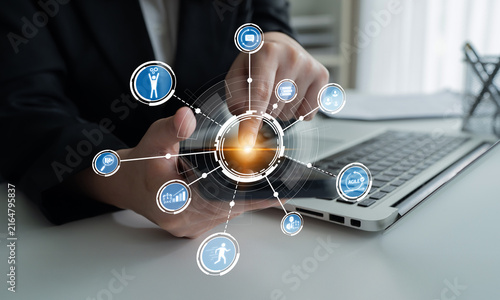 Fotografie A business professional interacts with technology at a modern workspace, showcasing the importance of data and digital communication in today business environment