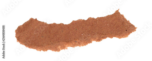 Small pile of brown cinnamon powder spice isolated on a plain surface