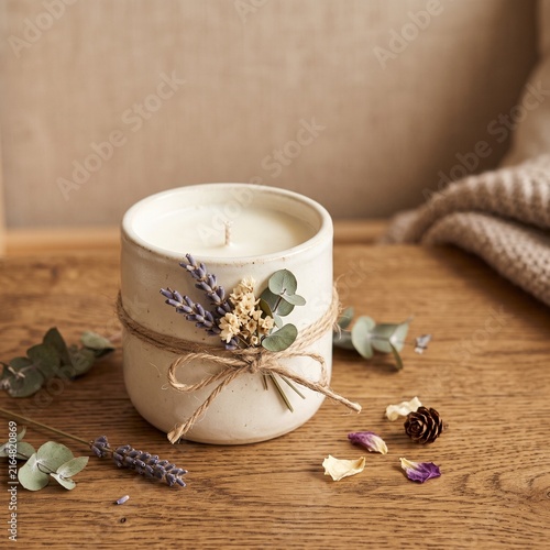 Handmade lavender and herb souvenir candle in rustic natural home decor setting