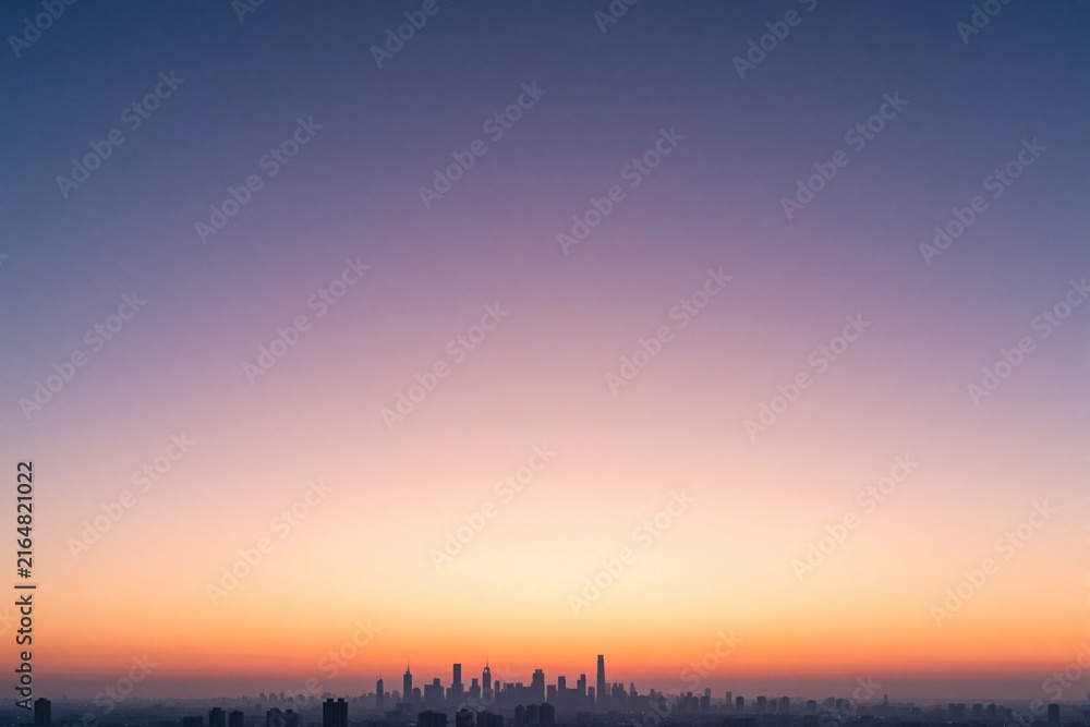 Fototapeta premium Minimalist city skyline at dawn with pastel colors. Soft pink, orange hues blend into vast sky above urban buildings. Quiet morning landscape offers serene atmosphere, huge copy space for design