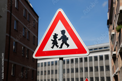 Children road sign in the Czech Republic. Warning symbol for road users in the city. Drive with caution because of crossing kids.