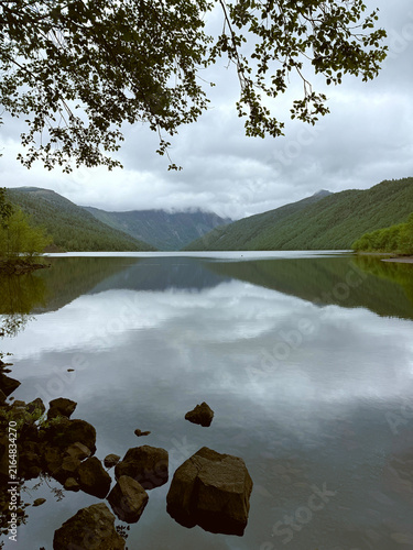Canvas Print Misty mountain lake with mirror-like reflections