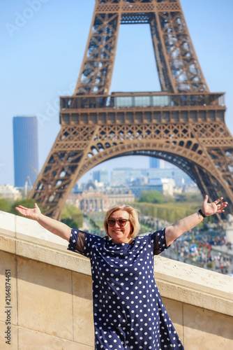 Woman Posing with Arms Outstretched in Front of Eiffel Tower