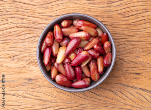 Cooked pinions or araucaria seeds on a bowl over wooden table