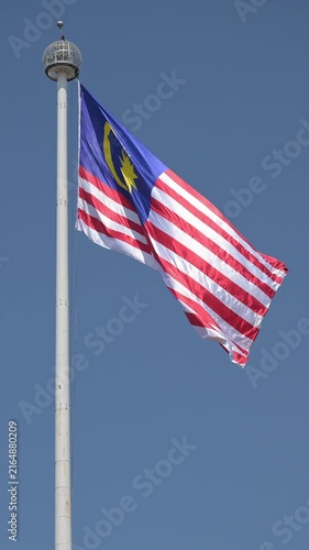 Malaysian flag in the wind on the huge pole at Merderka square, Kuala Lumpur, Malaysia