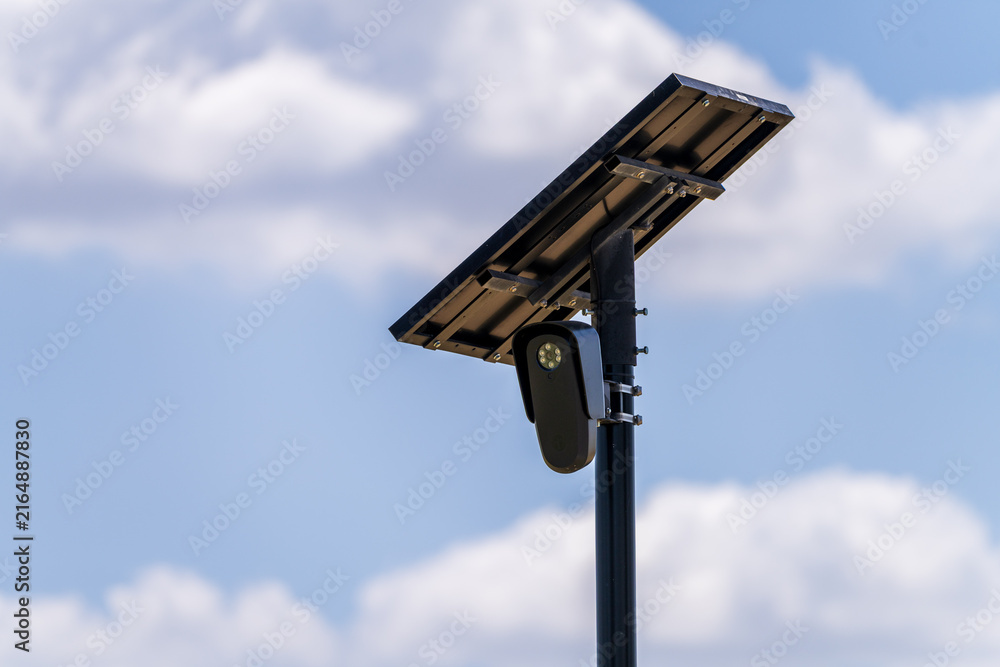 Naklejka premium Solar powered automatic license plate reader camera installed on a suburban street pole for traffic monitoring near Georgetown Texas