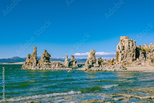 Bild auf Leinwand Weathered tufa towers stand partly submerged in the rippling waters of Mono Lake
