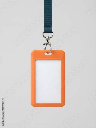 Blank orange plastic id badge holder with a blue lanyard hanging against a plain light background
