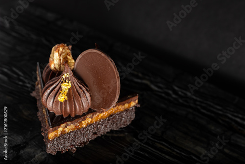 Close-Up of Rich Indulgent Chocolate Turtle Brownie Dessert on a Dark Background