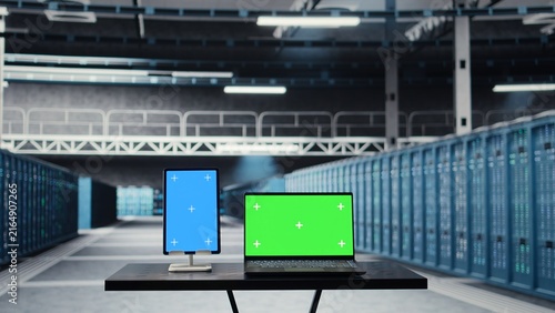 Obraz na plátne Green screen laptop and mockup tablet are used for data center maintenance to prolong electronics life span; chroma key devices help monitor hardware rigs in a server hub and prevent system crashes