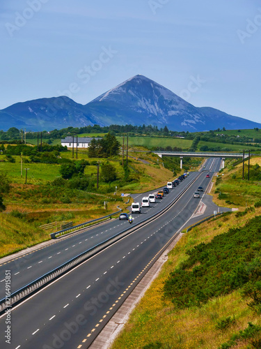 Cuadro en lienzo Motorway with a government car cartage and support vehicle, Famous Croagh Patrick in the background