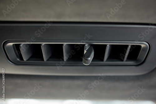 Foto Close-up car interior roof air vent with hanging fragrance clip in black fabric