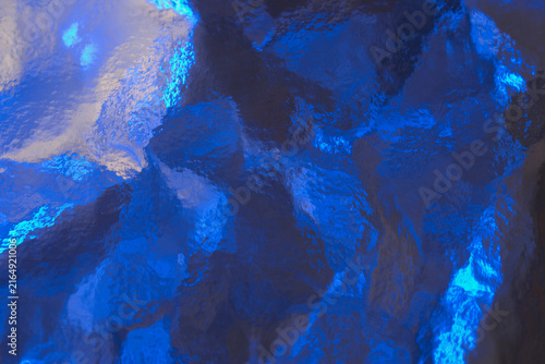фотографія Electric blue textured glass surface with abstract patterns.