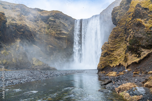 View of the majestic Skogafoss waterfall in southern Iceland on a cloudy day in March