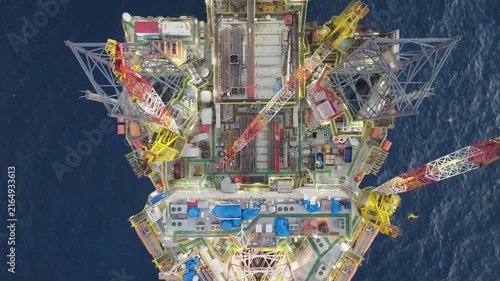 Offshore drilling rig - jack up and offshore platform during sunset for oil and gas exploration and production. 