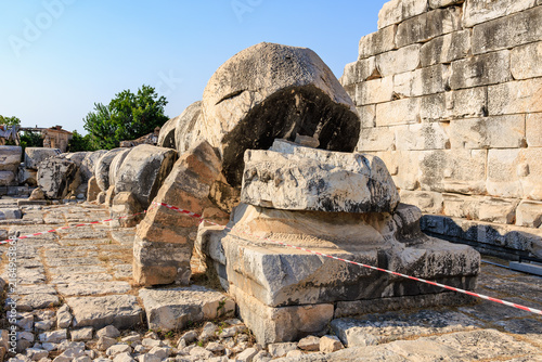 Bild auf Leinwand Ancient ruins of Temple of Apollo with fallen columns in scenic outdoor setting