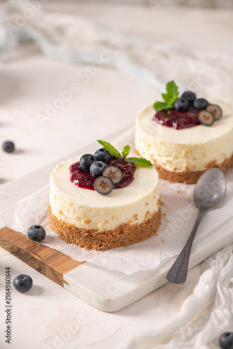 Mini cheesecakes with blueberry compote on a marble board