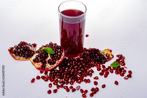 Quadro su tela Pomegranate juice in glass on white background