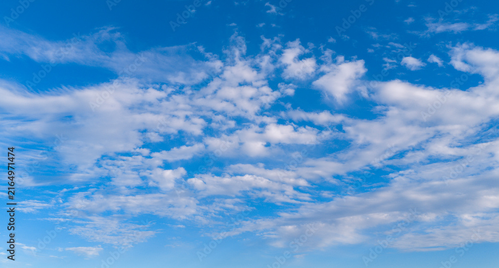 Fototapeta premium Clouds in sky background blue pattern. Soft white clouds on texture. Bright daylight clouds on wallpaper backdrop. Clouds cumulus skyscape.