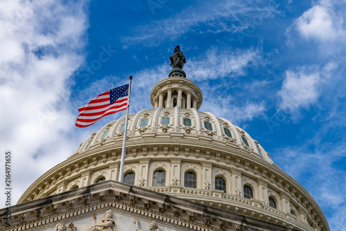 Fotografie American flag Capitol dome Washington DC clouds