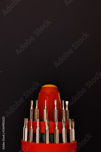 Bild auf Leinwand Multi bit screwdriver set showing variety of interchangeable metal heads in red