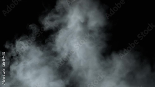 Thick white smoke swirls and billows against a dark black background in a studio setting.