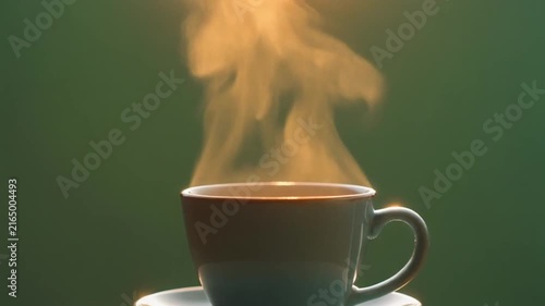 Steaming ceramic cup of coffee rising warm vapor in this soft focus cinematic motion video clip