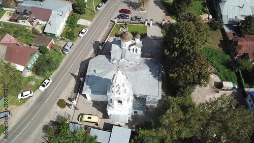 Drone tilts downward over church roofs