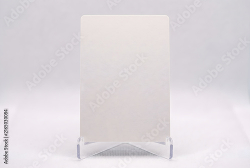 Blank vertical white card on transparent display stand mockup