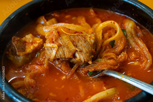 Canvastavla Metal Spoon Scooping Tender Braised Pork Rib and Tangy Aged Kimchi