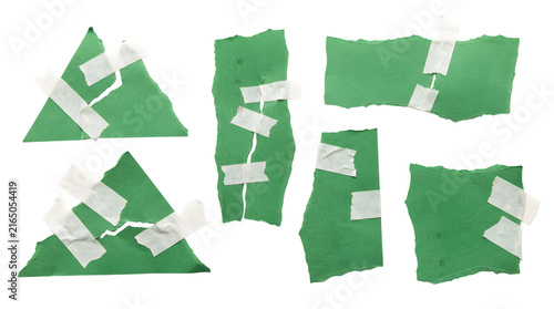 Torn green paper pieces, a collection of ripped paper fragments with adhesive tape, abstract texture elements for design, isolated on white background