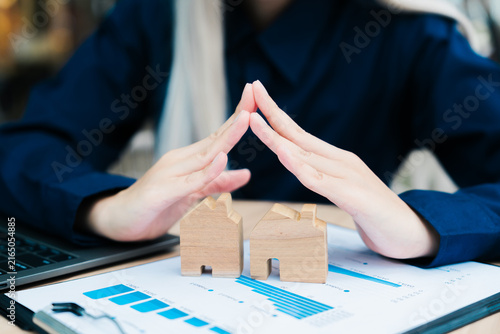 Obraz na płótnie Person protect house roof wooden model secure security safety insurance care pro