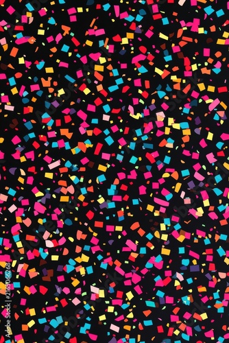 Colorful confetti scattered on a black background