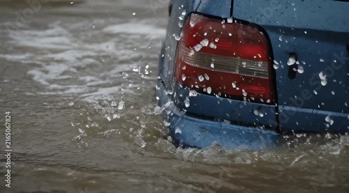 Submerged Rear View of a Vehicle in Floodwaters with Visible Ripples and Splashes