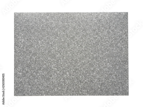 Surface made of silver metallic sparkling material lies flat on a plain white backdrop.
