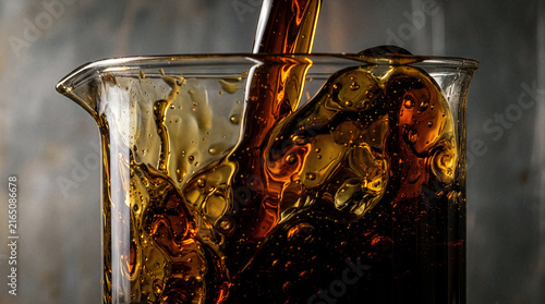 Crude Oil Pouring into Glass Container Close Up Petroleum Concept 1