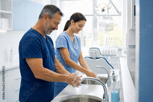 Dental Team Preparing Hands Before Patient Care