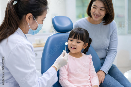 Pediatric Dentist Reassuring Child Before Checkup