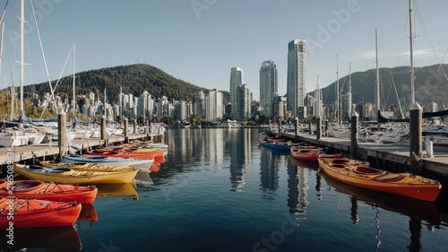 Harbor City Skyline With Boats And Distant Mountains Reflections.