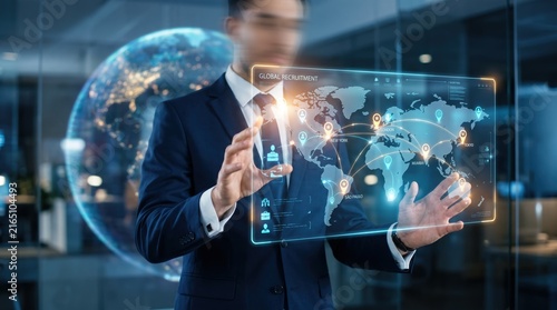 Businessman interacting with futuristic global recruitment interface showing world map and connection lines, human resources management, international hiring and talent