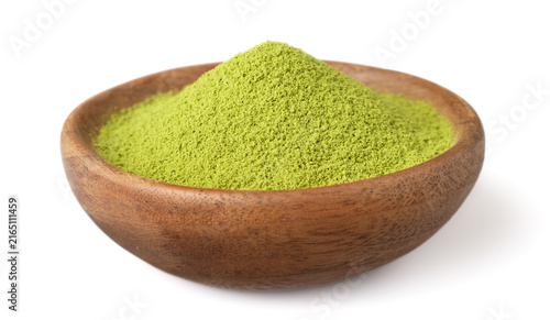 A small pile of matcha powder in the wooden plate, isolated on white background.