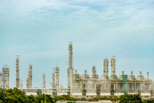 An oil and gas industrial refinery set against coldly blue sky, Steel pipelines for oil refineries and petrochemical plants. Oil refinery with steel storage tanks and pipelines.