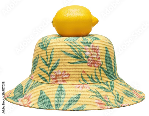 Yellow floral bucket hat with fresh lemon on top with transparent backdrop